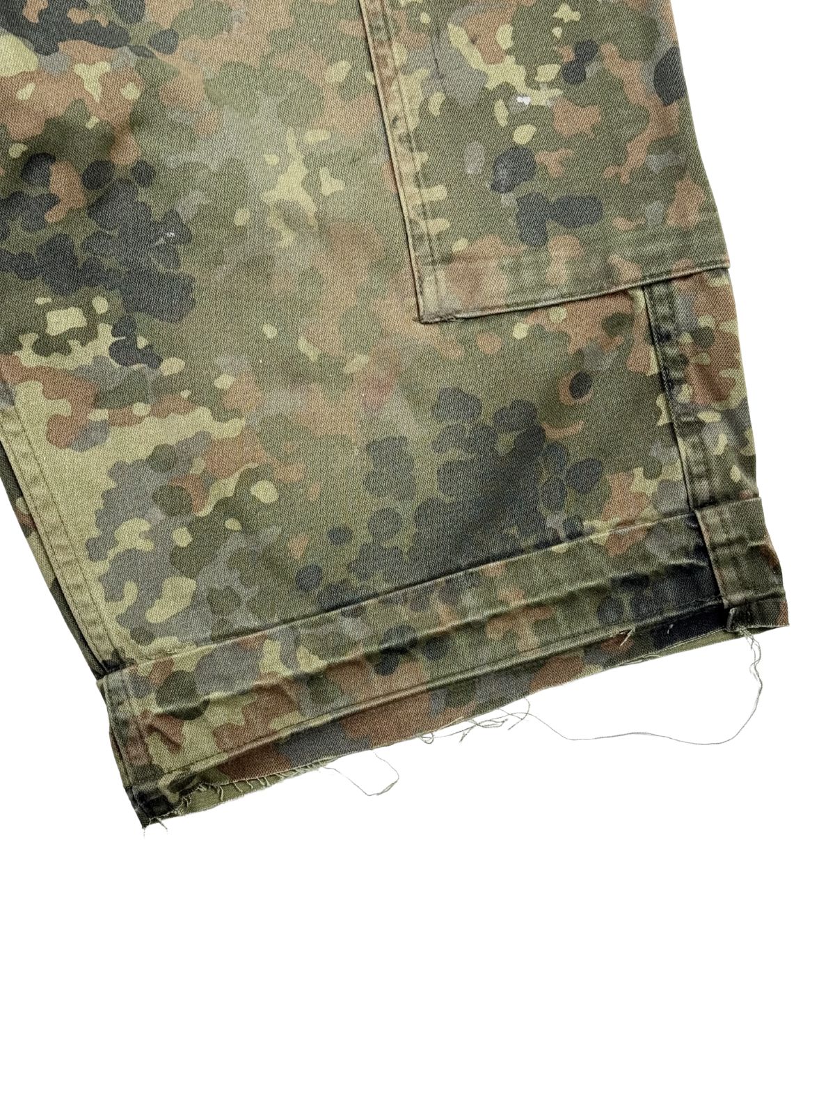 Detailansicht des linken Hosenbeins. Gut zu erkennen sind das abgeschnittene (cut-off) Beindeisign mit einer offenen, leicht ausfransenden Kante und herabhängenden Fäden.