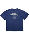 Rückseite eines dunkelblauen Cockney Rejects Vintage Band-Shirts mit der „Tour 2000 Germany“ Grafik und einer Liste deutscher Konzertstädte (Berlin, Hamburg, Krefeld, Leipzig, München).