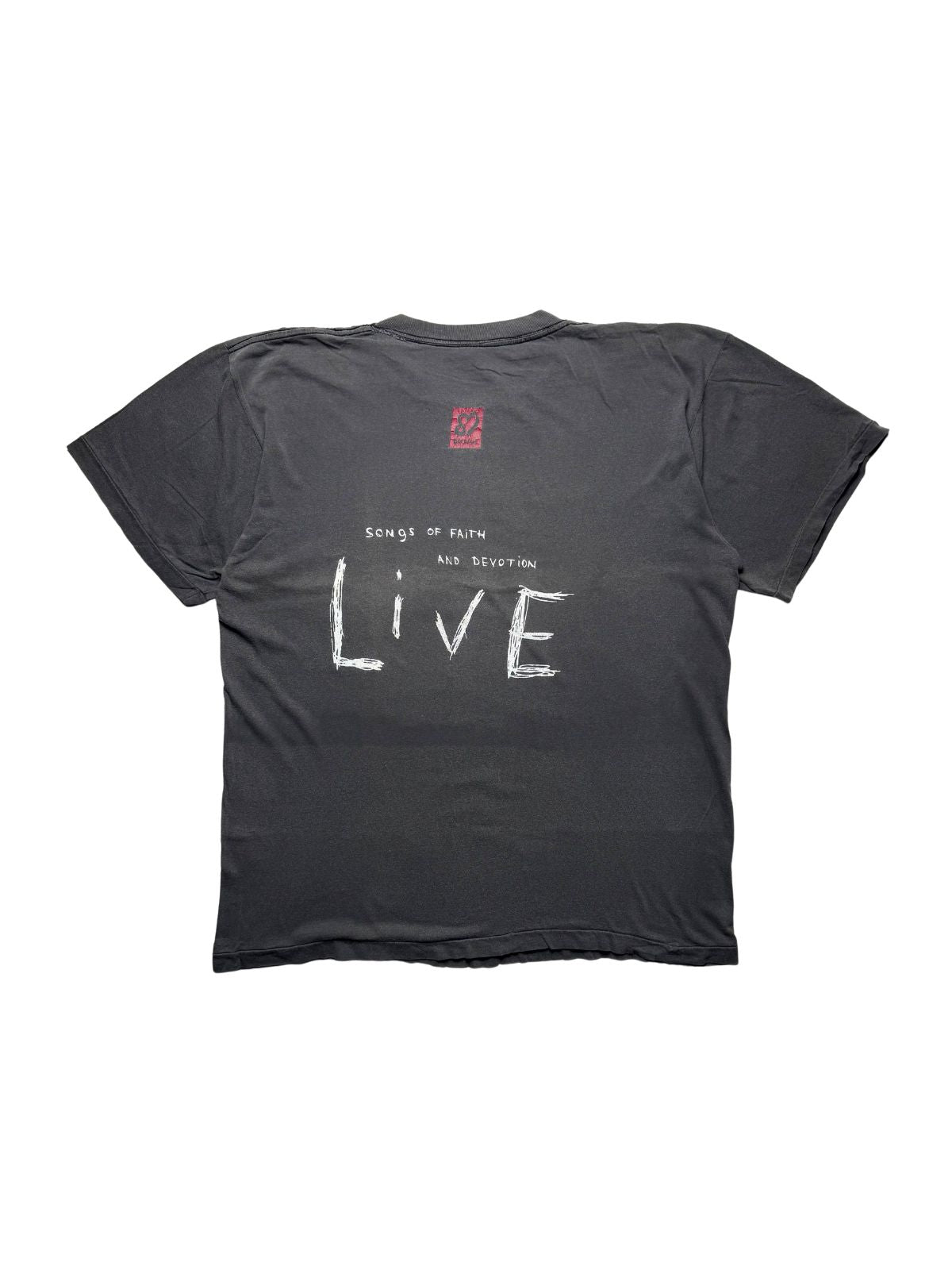 Rückseite des verwaschenen schwarzen Depeche Mode Vintage-Shirts von 1993 in der Gesamtansicht mit weißem „Songs of Faith and Devotion LIVE“-Backprint.