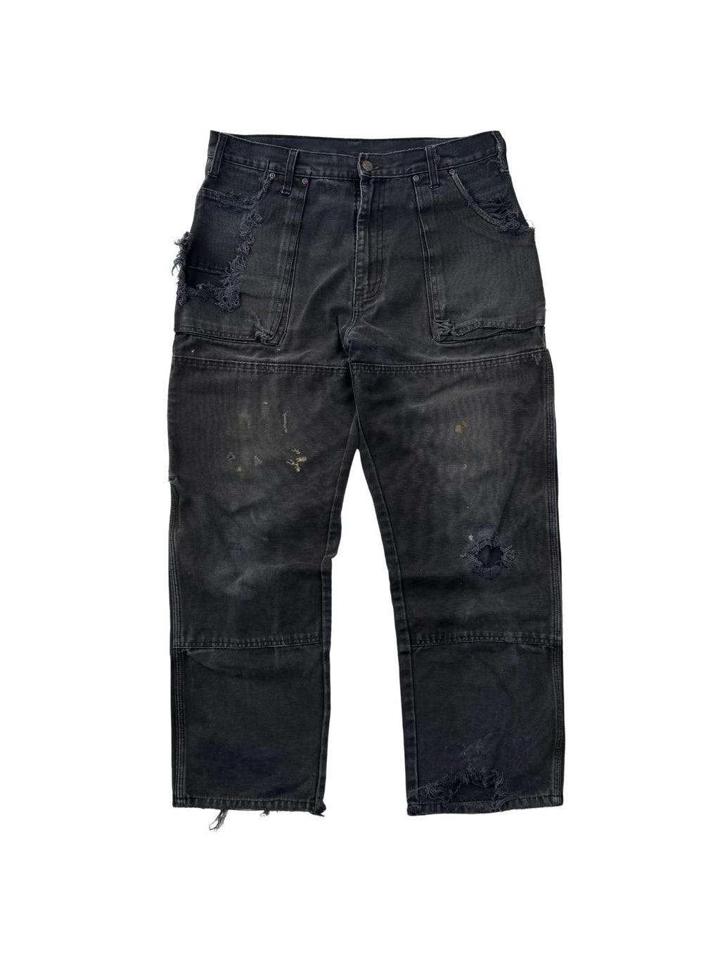 Vorderansicht einer thrashed Vintage Dickies Double Knee Hose in verwaschenem Schwarz mit starken Distressed-Details und Farbspritzern.