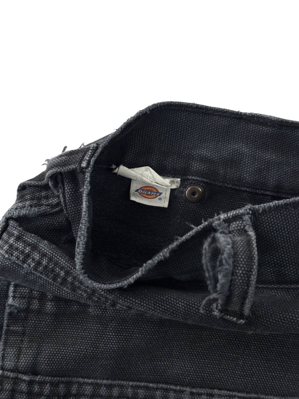 Innenansicht des gewebten Dickies Marken-Logos am Hosenbund einer schwarzen Vintage Double Knee Pants.