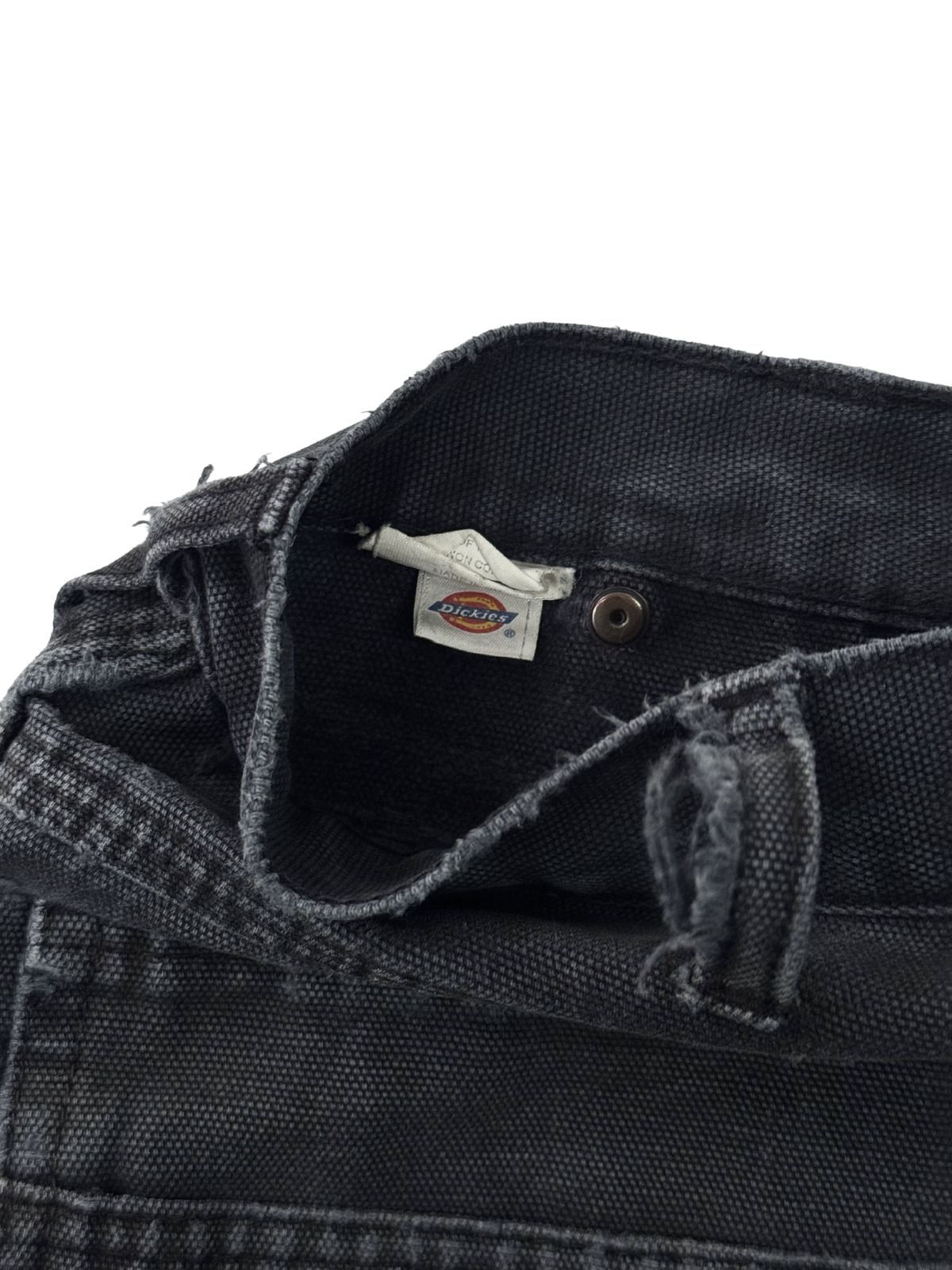 Innenansicht des gewebten Dickies Marken-Logos am Hosenbund einer schwarzen Vintage Double Knee Pants.