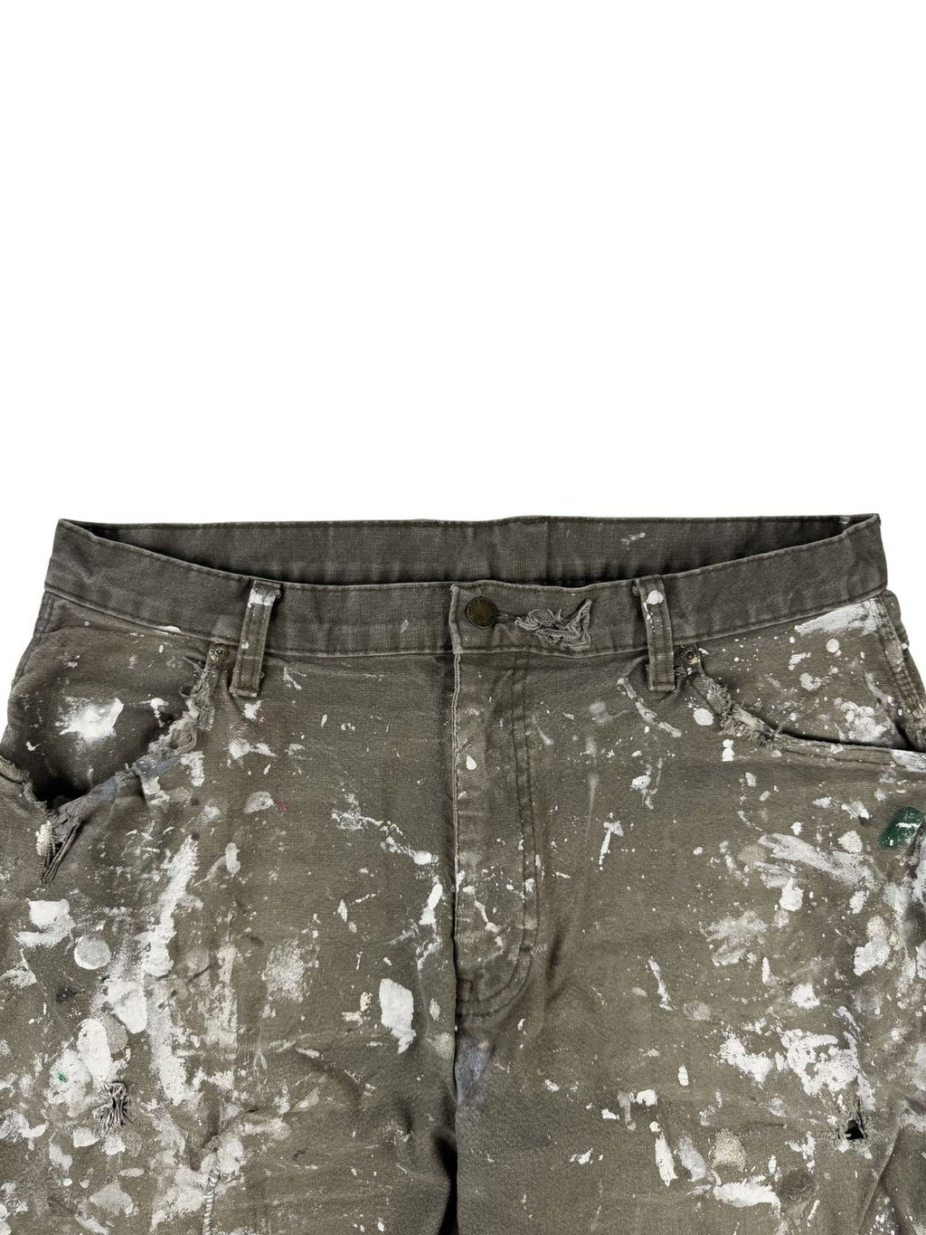 Detailansicht der vorderen Bundpartie. Die Vorderseite der Hose zeigt ein extremes Distressed-Muster aus weißen Farbschmierern sowie stark eingerissene, ausgefranste Ränder an beiden Eingriffstaschen.