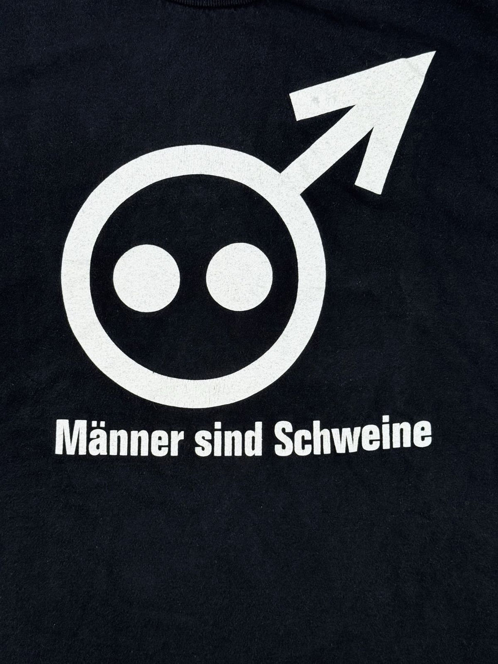 Detailansicht des vorderen Siebdrucks mit dem kombinierten Männersymbol und Schweinerüssel sowie dem darunter platzierten Songtitel „Männer sind Schweine“.