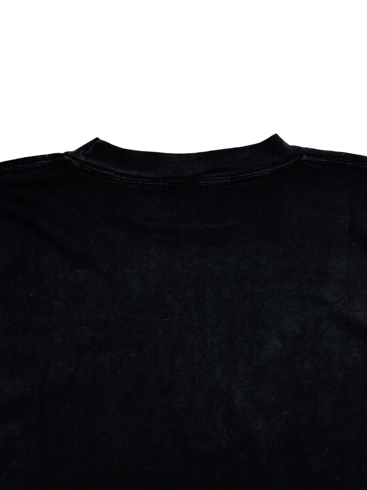 Detailaufnahme der oberen Rückseite mit dem intakten, leicht elastisch gerippten Halsbündchen auf dem ausgewaschenen schwarzen Stoff.