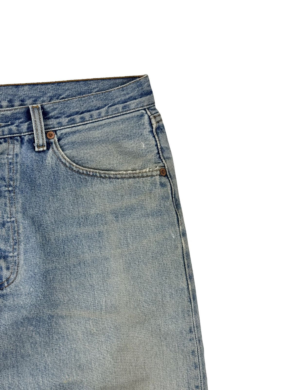 Detailaufnahme der vorderen linken Hüftpartie mit der klassischen Eingriffstasche und den kupferfarbenen Nieten auf hellem Vintage-Denim.