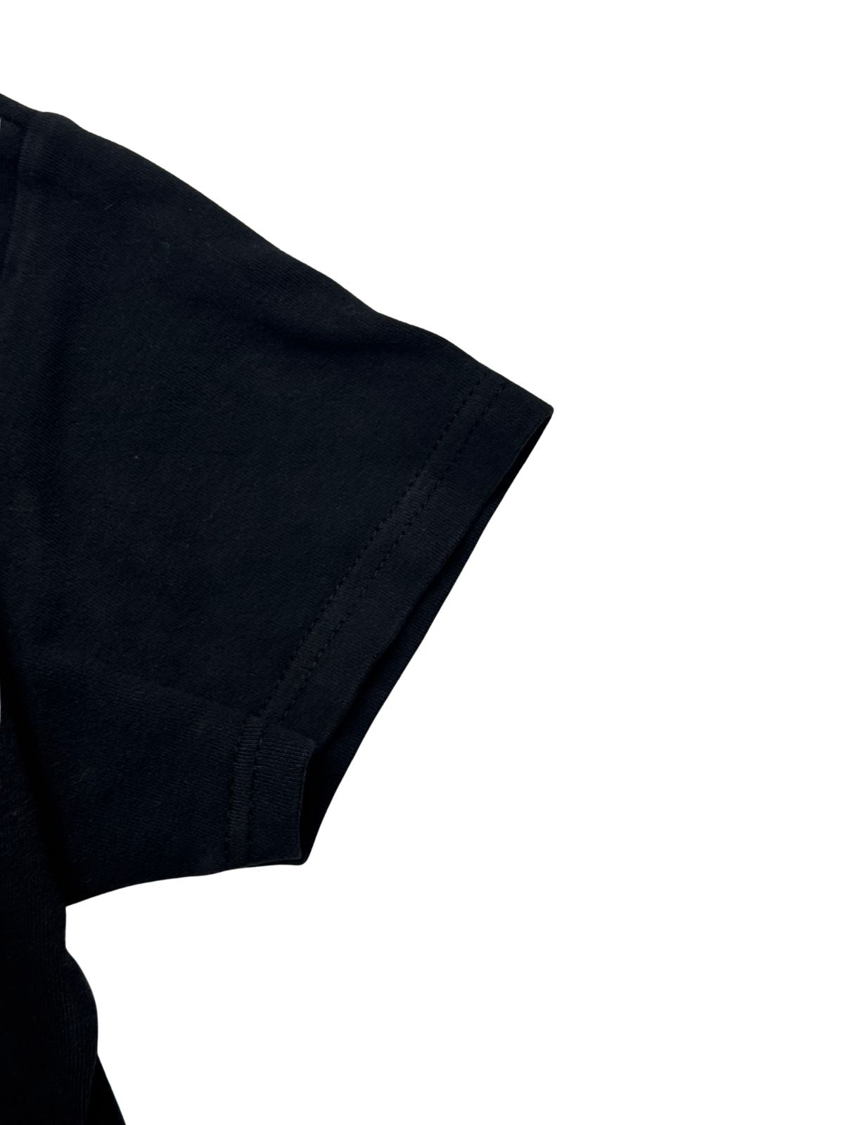 Detailansicht des kurzem Damen-Ärmels mit sauberer Doppelnaht auf schwarzem Baumwollstoff.