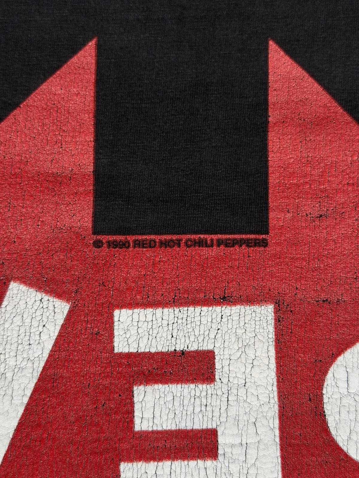 Makroaufnahme des Copyright-Aufdrucks auf der Rückseite des Shirts: „© 1990 RED HOT CHILI PEPPERS“.