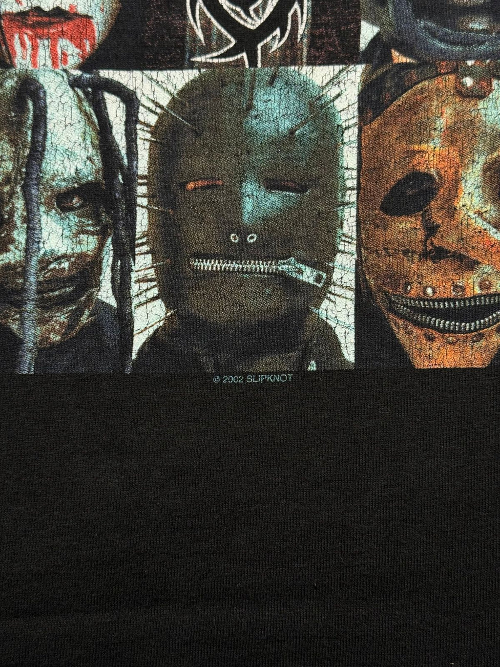Makroaufnahme des geplotteten/gecrackten Backprints mit der sichtbaren Lizenzzeile „© 2002 SLIPKNOT“ zur Echtheitsbestätigung.